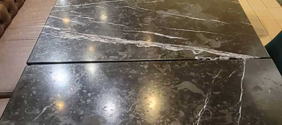 Marble table showing bad etching and staining.